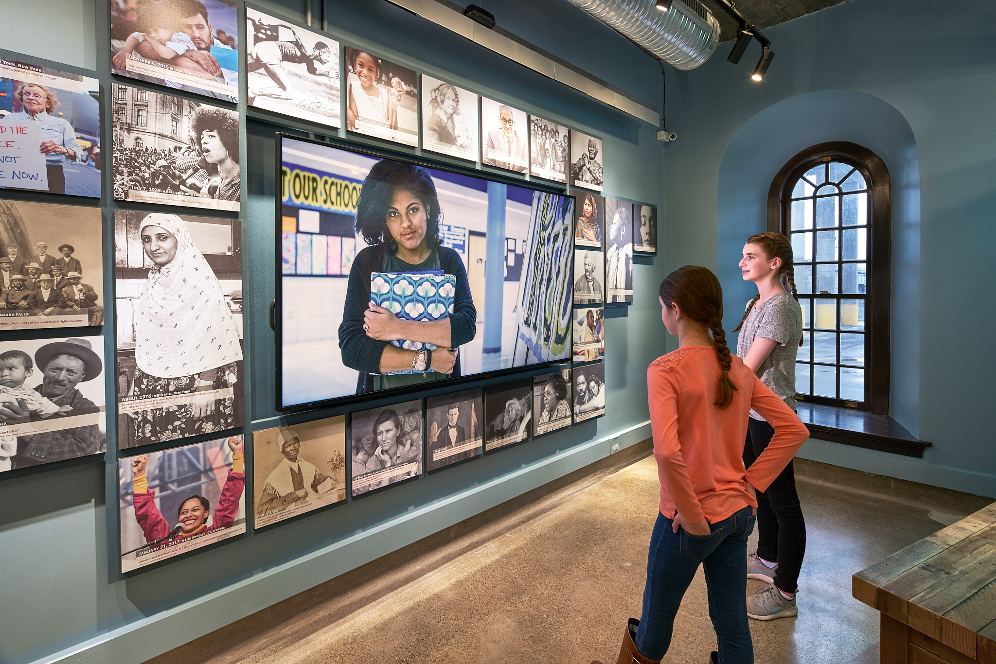 Figure 6. A media piece featuring five local Western New Yorkers anchors the gallery with contemporary stories that speak to universal messages of freedom. Niagara Falls Underground Railroad Heritage Center, Freedom Gallery. Photo: Copyright 2018 Kim Smith Photo and Seth Frankel/Studio Tectonic.